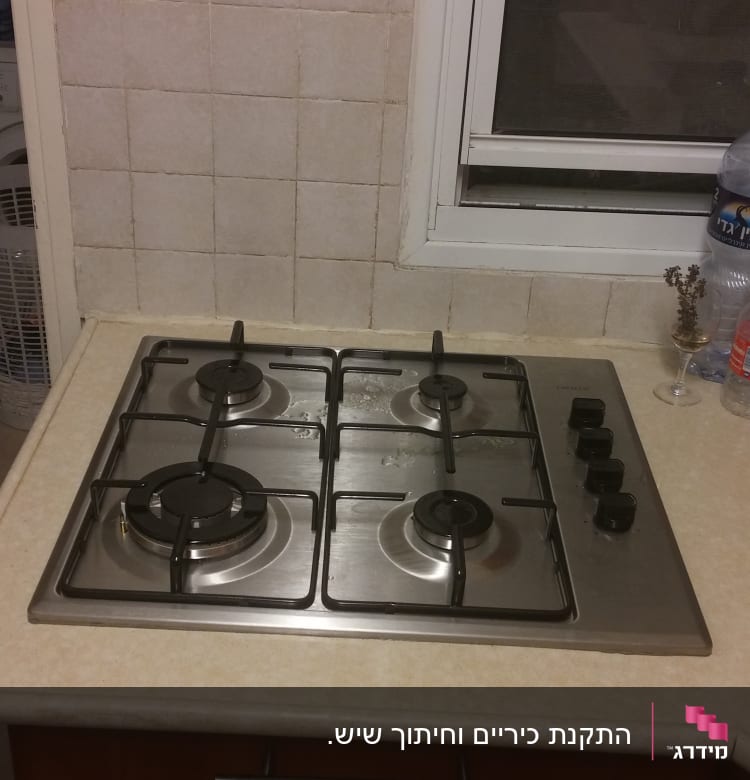 כיריים גז עם ארבעה מבערים וכפתורי שליטה